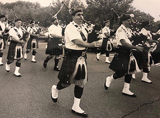The Men Playing The Bagpipes On The Street Parade